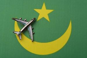 Plane over flag Mauritania, the concept of journey. photo