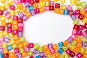 Many colorful decorative cubes with letters on a white background. photo