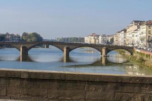 View of the Arno river in Florence, Tuscany, Italy, from Ponte Vecchio. Bridge at a distance of Ponte alle Grazie. photo