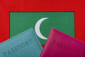 On the background of the flag of Maldives two passports. photo