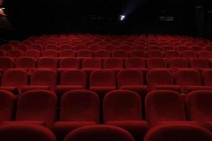 Empty cinema hall with red seats. Movie theater. photo