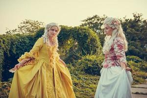 Portrait of two blonde woman dressed in historical Baroque clothes photo