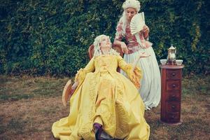 Portrait of two blonde woman dressed in historical Baroque clothes photo