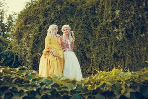 Portrait of two blonde woman dressed in historical Baroque clothes photo
