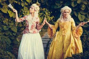 Portrait of two blonde woman dressed in historical Baroque clothes photo