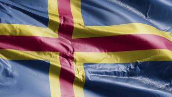 aland flagga vajar på vindslingan. aland banner vajande på vinden. full fyllning bakgrund. 10 sekunders loop. video