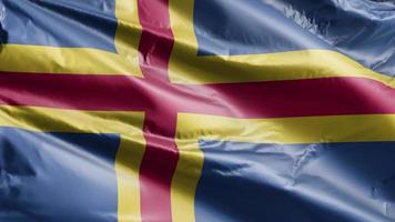 aland flagga långsamt viftande på vindslingan. aland banner smidigt vajande på vinden. full fyllning bakgrund. 20 sekunders loop. video