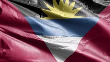 Antigua and Barbada textile flag slow waving on the wind loop. Antigua and Barbada banner smoothly swaying on the breeze. Fabric textile tissue. Full filling background. 20 seconds loop. video