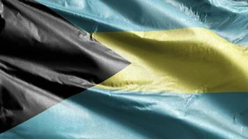 Bahamas textilflagga vajar långsamt på vindslingan. bahamian banderoll smidigt vajande på vinden. tyg textilvävnad. full fyllning bakgrund. 20 sekunders loop. video