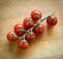 tomatoes on brown textured wood photo