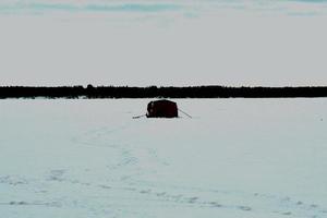 winter in Manitoba - ice fishing on a frozen lake photo