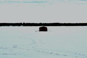 winter in Manitoba - ice fishing on a frozen lake photo