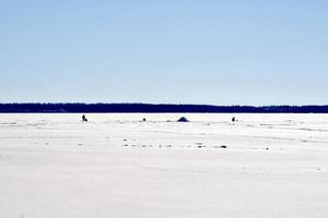 winter in Manitoba - ice fishing on a frozen lake photo