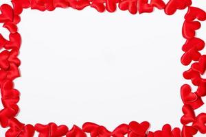 Valentine's day greeting card. Frame from red hearts on a white background. photo
