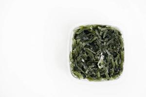 Seaweed in a plastic package on a white background photo