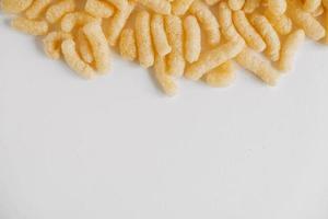 Corn sticks on a white background. Top view. Place for your text photo