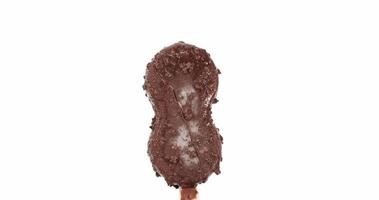 Melting of chocolate covered ice cream sticks. Gradually dissolved into water. On the white background. video