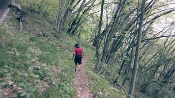 Child runs in a forest path video