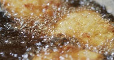 Close - up  Nuggets are being fried in boiling oil. The oil is boiling on a high heat stove. video