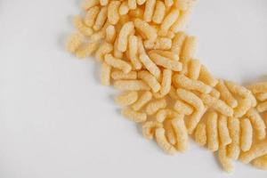 Corn sticks on a white background. Top view. Place for your text photo
