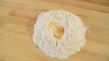 Bakery mixes Eggs with Flour - preparing of a Biscuit Cake