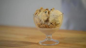Eiscreme-Vanillegelato wird mit Walnusskernen bestreut video