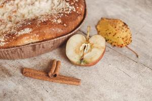 Tarta de manzana casera y canela sobre textura de fondo de madera vintage. vista superior. copiar, espacio vacío para texto foto