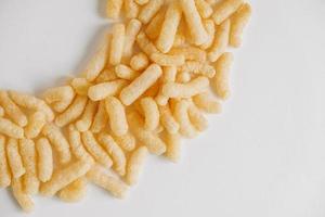 Corn sticks on a white background. Top view. Place for your text photo