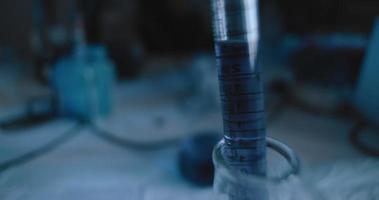 Close up shot of purple liquid being put into a conical flask. video