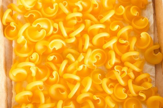 Yellow pasta as a background image. Top view. Copy, empty space for text photo