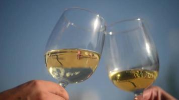 Close Up Of Two Wine Glasses Being Toasted At the Blue Sky video