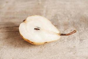 Sliced pear on a old wood background photo