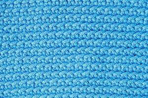 Blue knitted fabric texture background. Top view. Copy, empty space for text