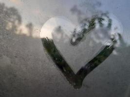 Love sign on fogging glass photo