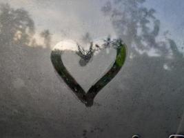 Love sign on fogging glass photo