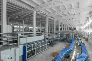 Tashkent, Uzbekistan - June 7, 2016 - Plant for the production of plastic bottles.  Plastic bottles on a conveyor belt. Bottled water filling photo