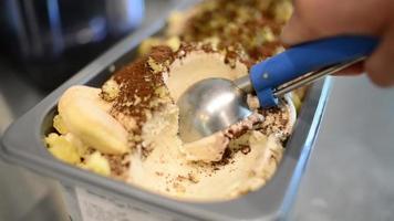 Close Up Banana Ice Cream Scooping Out Of Container video