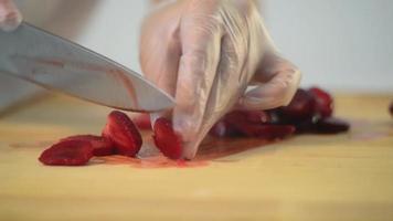 The Baker cuts Strawberries with a Knife