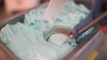 Close Up blue Ice Cream Scooping Out Of Container to a Cone video