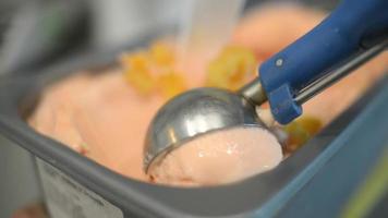 Close Up fruity Ice Cream Scooping Out Of Container to a Cone video