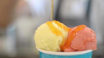 Ice cream fruity Gelato is sprinkled with yellow Peach Jam topping video