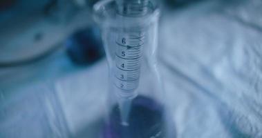 Tracking close up shot of purple liquid being taken out from a conical flask. video