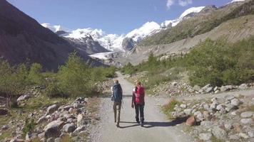 Two friends during a Alpine trek towards a glacier video