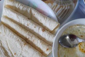 homemade roti chapati and egg on table, top view photo