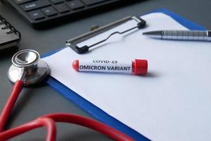 omicron variant corona virus blood test tube on red background photo