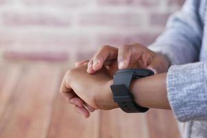 man's hand using smart watch. photo