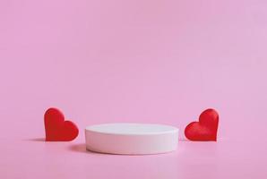 Valentine's day background with podiums for products or cosmetics with hearts on a pink background. closeup. photo