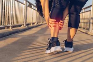 woman doing leg massage on footbridge photo