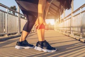 woman doing leg massage on footbridge photo