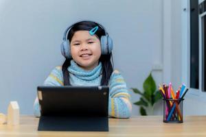 Children study online through tablets at home. photo